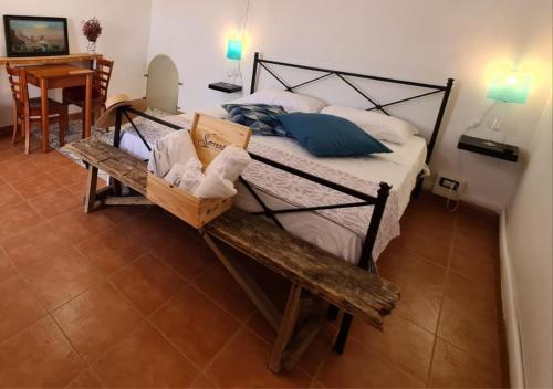 a bedroom with a bed with a bench and a table at Vesuvio Inn Guest House e Wine Experience in Boscotrecase