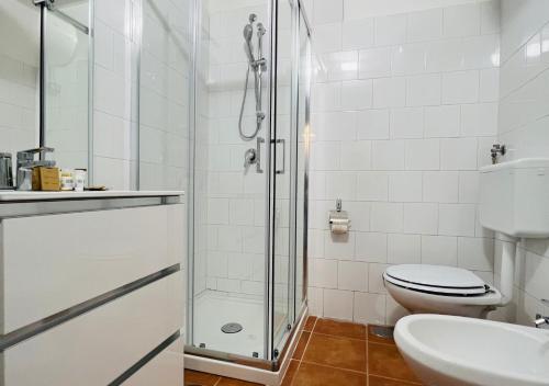 a bathroom with a shower and a toilet and a sink at Vesuvio Inn Guest House e Wine Experience in Boscotrecase