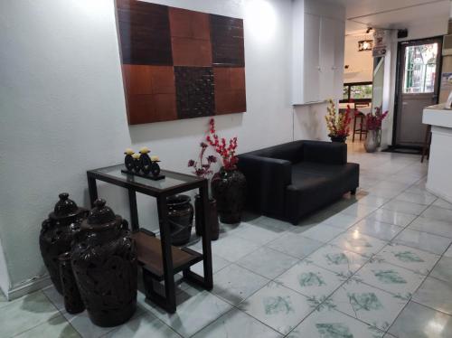 a living room with a couch and a table at Parkview Hotel in Cagayan de Oro