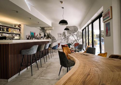 a bar with a wooden table and chairs at Hotel l'Isolella in Porticcio