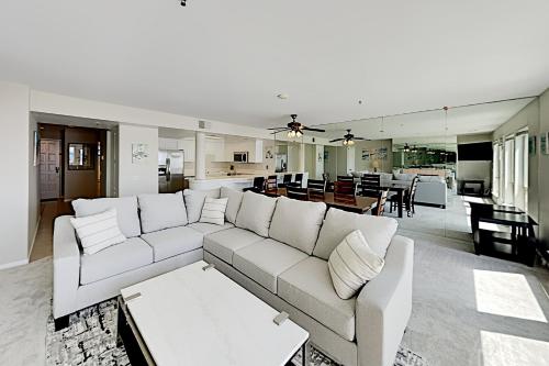 a living room with a white couch and a kitchen at Imperial Beach Club in Imperial Beach