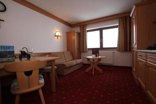 a living room with a couch and a table at Gast- und Ferienhof Christler in Tux