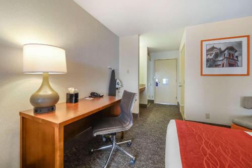 a hotel room with a desk and a bed at Comfort Inn Humboldt Bay in Eureka