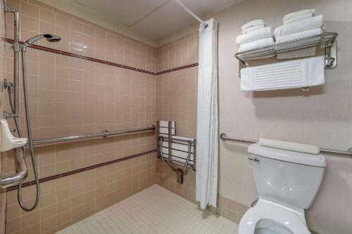 a bathroom with a toilet and a shower and towels at Comfort Inn Humboldt Bay - Eureka in Eureka