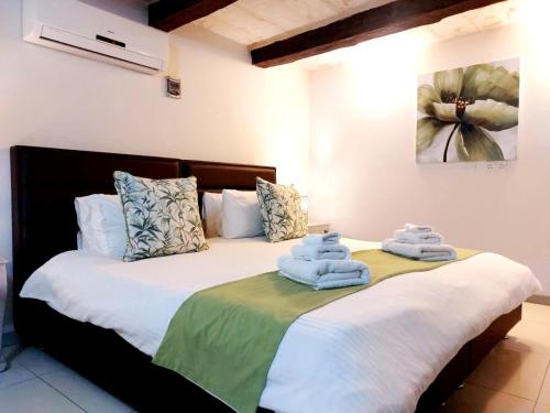 two beds in a room with towels on them at Casa Birmula Boutique Hotel in Cospicua