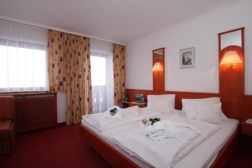 a hotel room with a bed with towels on it at Gast- und Ferienhof Christler in Tux
