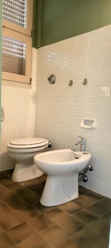 a bathroom with a toilet and a bidet at Hotel Millepini in Marina Romea