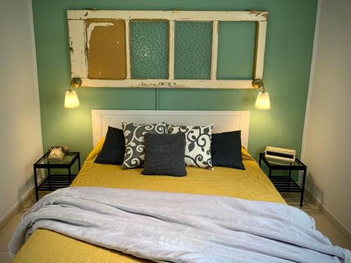 a bedroom with a bed with yellow sheets and pillows at Borgo Casinello in Marina di Pisticci