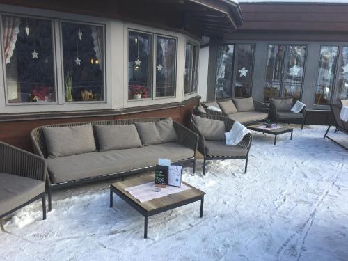 a living room with couches and tables and windows at Gast- und Ferienhof Christler in Tux
