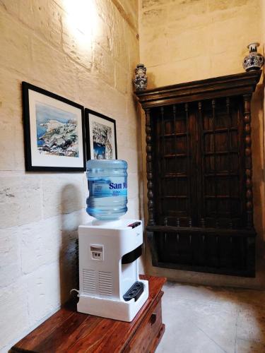 a water jug on top of a microwave on a table at Casa Birmula Boutique Hotel in Cospicua