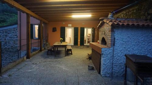 una casa con patio y chimenea de piedra. en Agriturismo U muinettu, en La Spezia