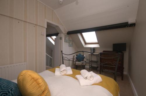 a bedroom with a bed with towels on it at Lizzys Little Kitchen Town Accommodation in Listowel