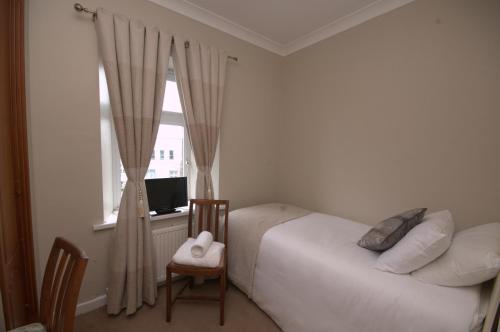 a bedroom with a bed and a window at Lizzys Little Kitchen Town Accommodation in Listowel