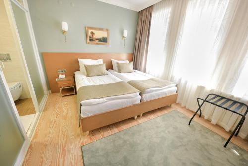 a bedroom with a large bed in front of a window at Uğurlu Konakları in Kastamonu