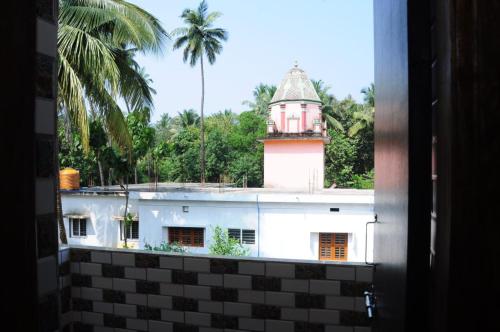 a view from a window of a building with a tower at Aryan residency in Māvalli