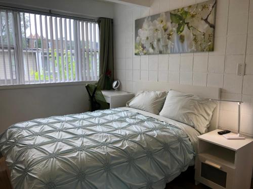 a bedroom with a white bed and a window at Hyde Park Modern Private Room - Near Univ of Chicago in Chicago