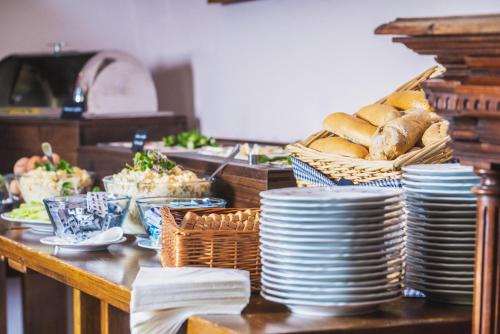 a table topped with plates and baskets of food at penzion Dvorce in Třeboň