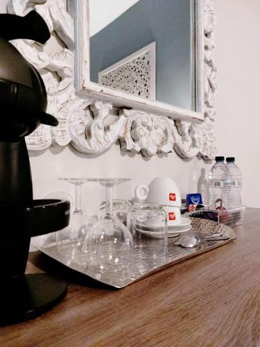 a tray with glasses and a mirror on a table at Casa Birmula Boutique Hotel in Cospicua