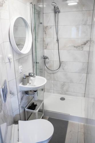 a bathroom with a shower and a toilet and a sink at Sun & Fun in Władysławowo