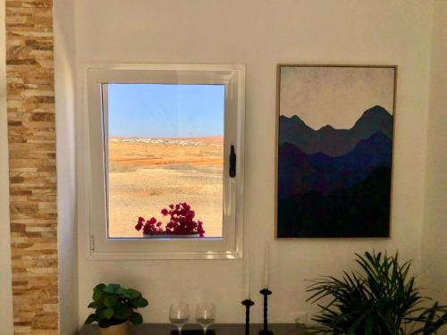 a window in a room with a view of the desert at Casa Lucilita in Valles de Ortega