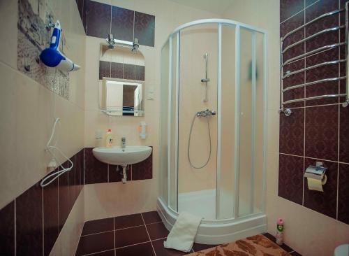 a bathroom with a shower and a sink at Molex Apartments 2 in Chernihiv
