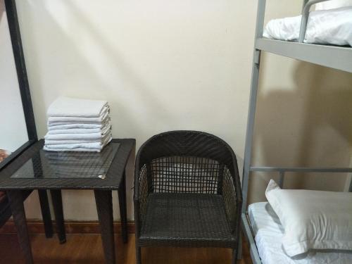 a table and a chair next to a bunk bed at Ngan Ha Homestay in Ha Giang