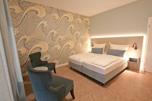 Кровать или кровати в номере Hotel Garni Goldener Anker