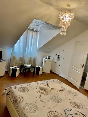 a bedroom with a bed and a chandelier at Unser Haus in Sibiu