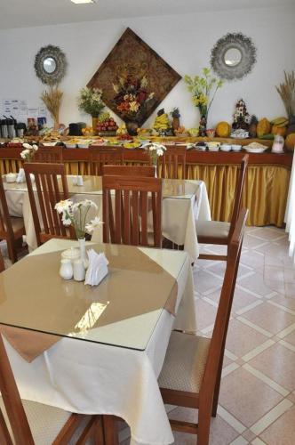 a restaurant with tables and chairs with flowers on it at Awki´s Dream Hotel in Cusco