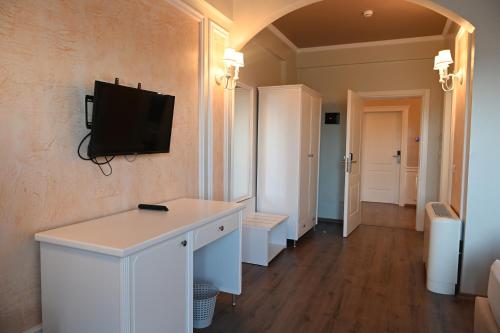 a living room with a tv on a wall at Hotel Onufri in Golem