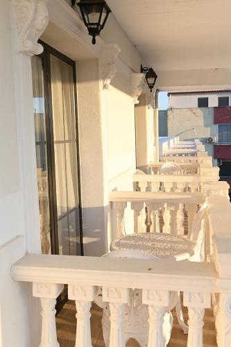 a balcony with a white railing on a building at Hotel Onufri in Golem