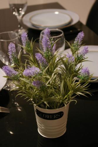 a vase filled with purple flowers on a table at BOUCHON POUR 4 Avenue de Champagne à 3 minutes in Épernay