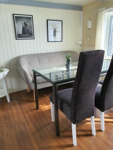 a living room with a table and a couch at Aline's Stue, B&B Utskarpen in Fuglstad