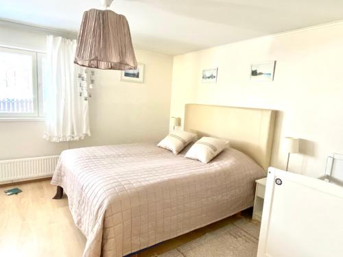 ein weißes Schlafzimmer mit einem Bett mit weißer Bettwäsche in der Unterkunft Kuivaketveleen Piha in Lappeenranta