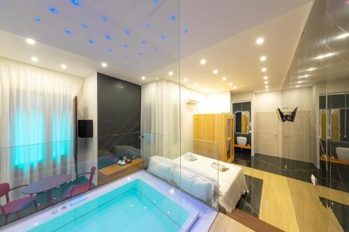 a room with a swimming pool and a bedroom at Abside Suite & Spa in Palermo