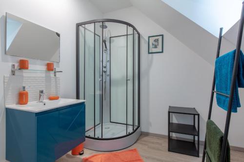 a bathroom with a glass shower and a sink at Près du Kiosque in Chémery