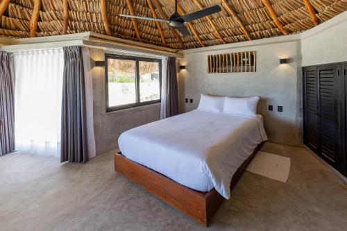 a bedroom with a bed and a window at Maya Tulum By G Hotels in Tulum