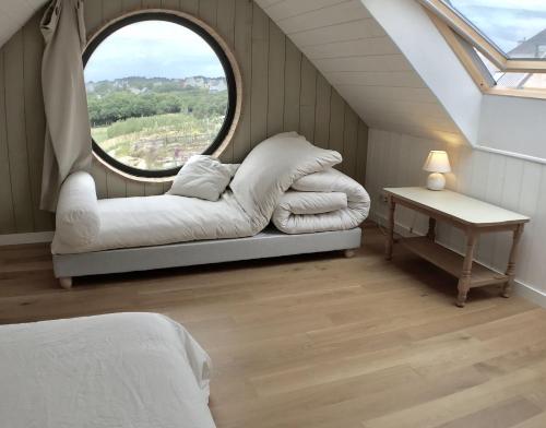 un lit dans une chambre avec une fenêtre dans l'établissement Dernier Ecolodge avant NewYork, à Plogoff