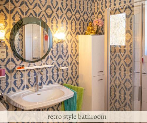 a bathroom with a sink and a mirror at Apartment Valerie - Villa Mühlei Alterbachstr 9 in Anif