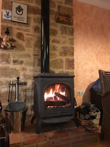 a stove in a room with a brick wall at Rosella de Rubielos in Fuentes de Rubielos