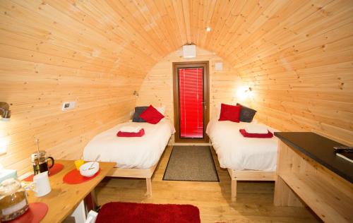 a room with two beds in a log cabin at Hadrian's Holiday Lodges in Greenhead