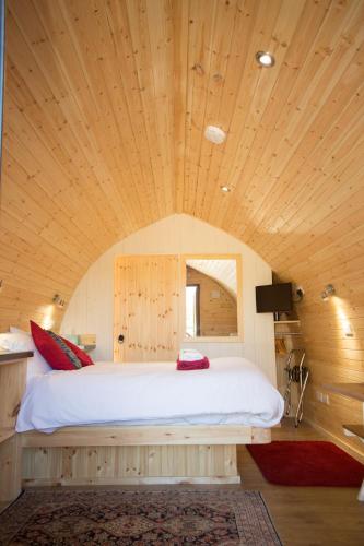 - une chambre avec un grand lit au plafond en bois dans l'établissement Hadrian's Holiday Lodges, à Greenhead