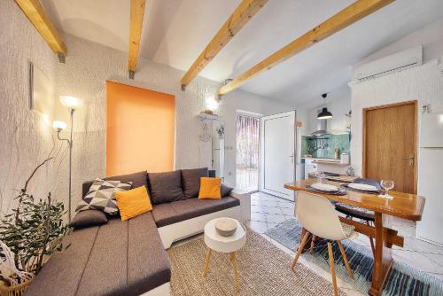 a living room with a couch and a table at Malo Fali in Vir