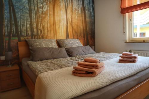 a bedroom with a bed with two towels on it at Edersee Aktivurlaub in Waldeck