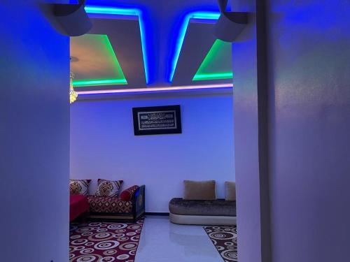 a room with a blue and green lights on the ceiling at HOUSE l impérial pour vacance in Aourir