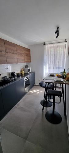 a kitchen with a table in the middle of it at Apartman ''Anno Domini'' in Rijeka