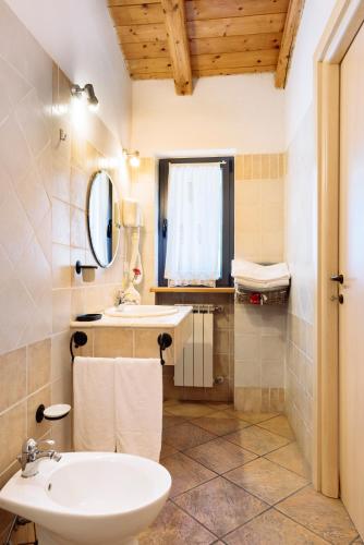 a bathroom with a sink and a toilet and a mirror at Il Fiorile in Borghetto Di Borbera