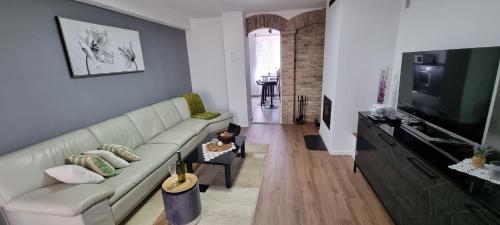 a living room with a couch and a flat screen tv at Apartman ''Anno Domini'' in Rijeka