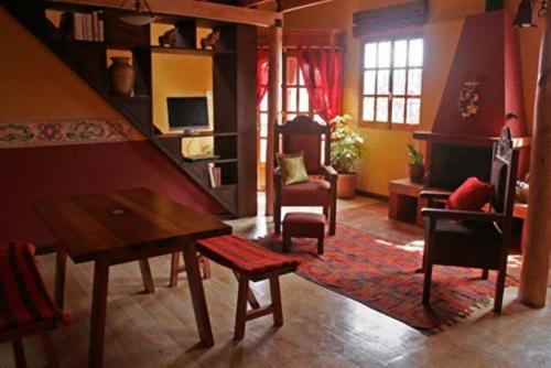 ein Wohnzimmer mit einem Tisch und Stühlen in der Unterkunft Quinua Boutique Apartments in Cusco