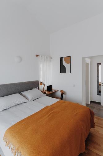 a bedroom with a large bed with an orange blanket at Villa Kadila with heated pool and sauna for family in Lun